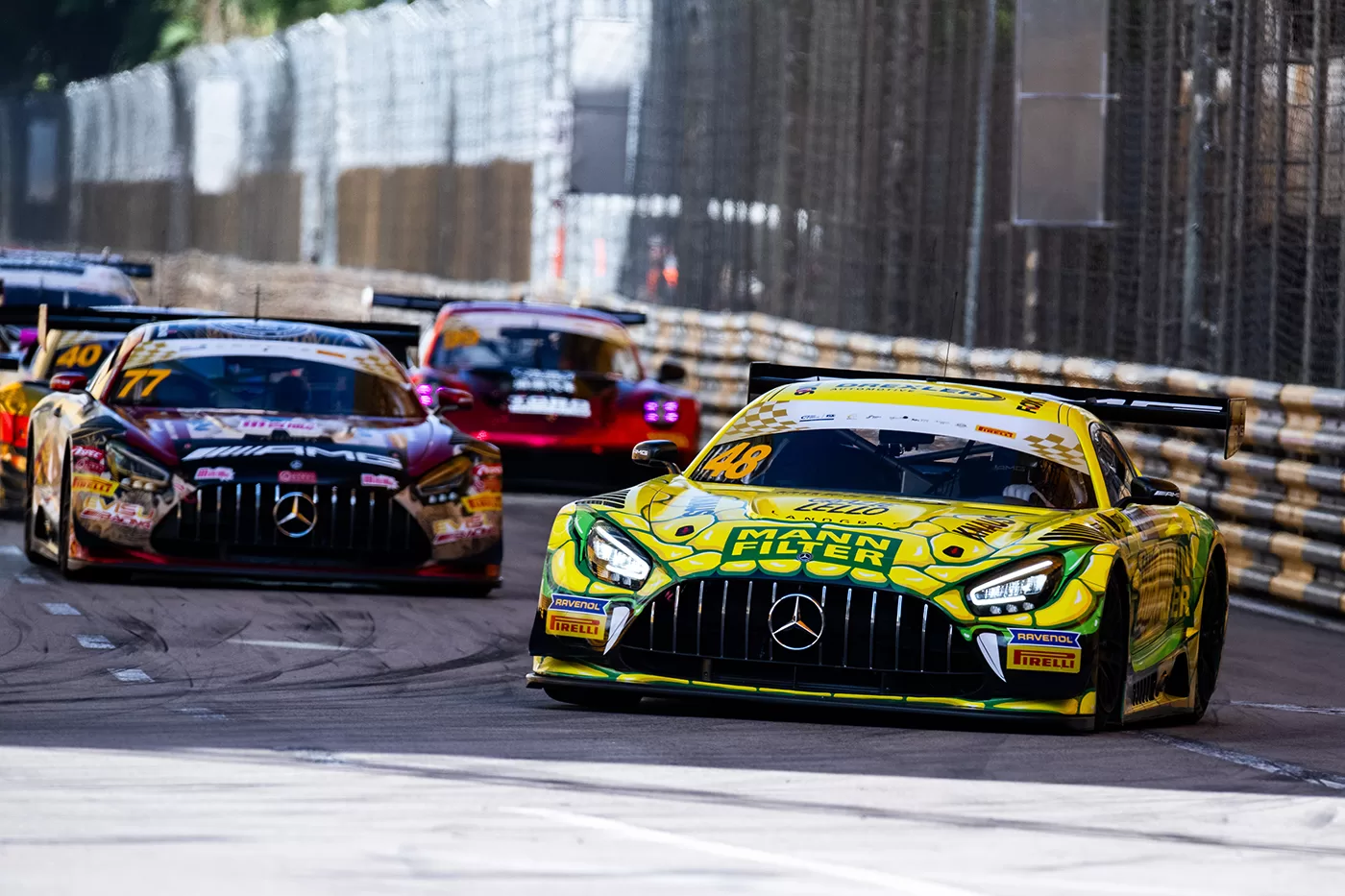 Yellow car racing next to a barrier