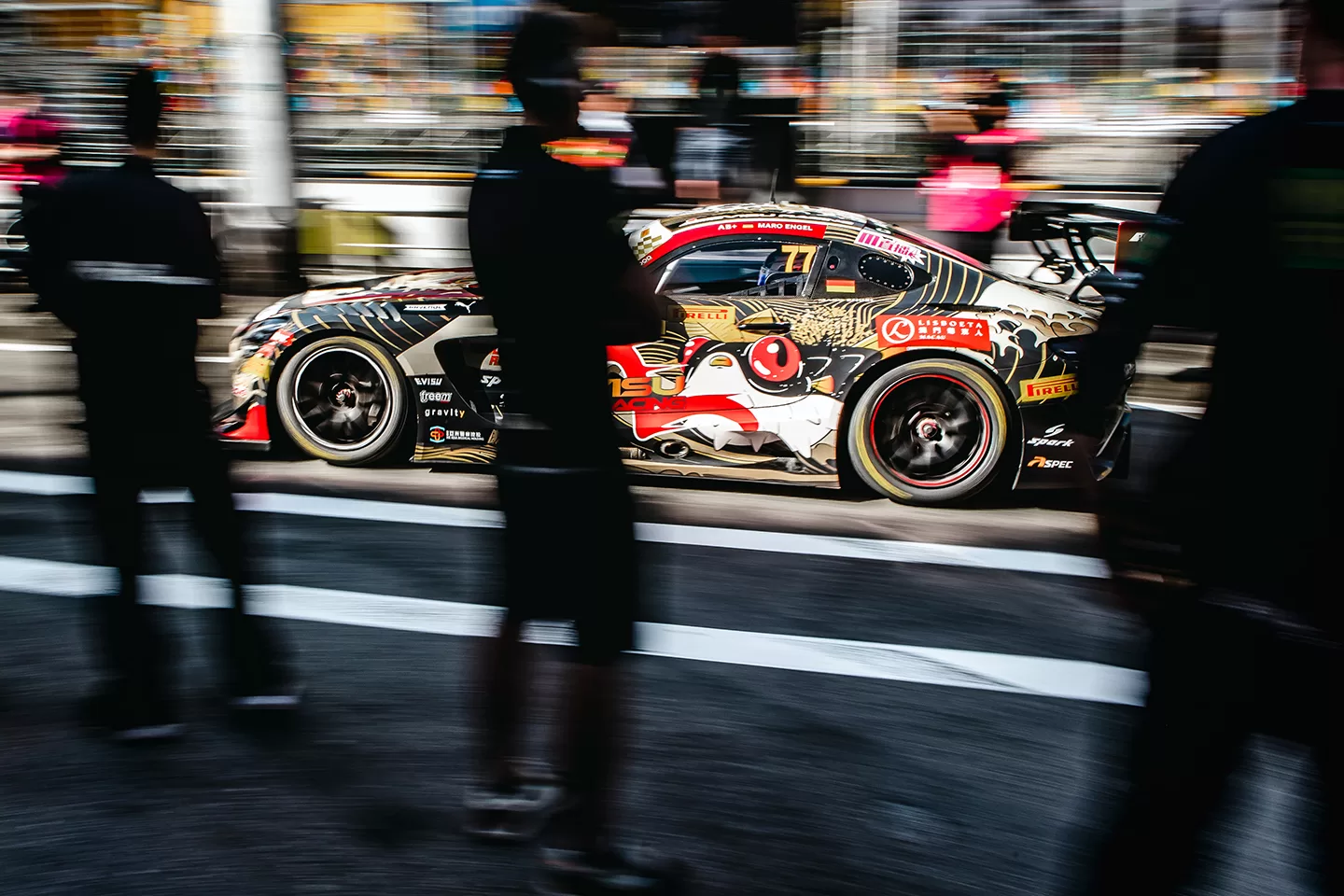 Car photographed behind three people