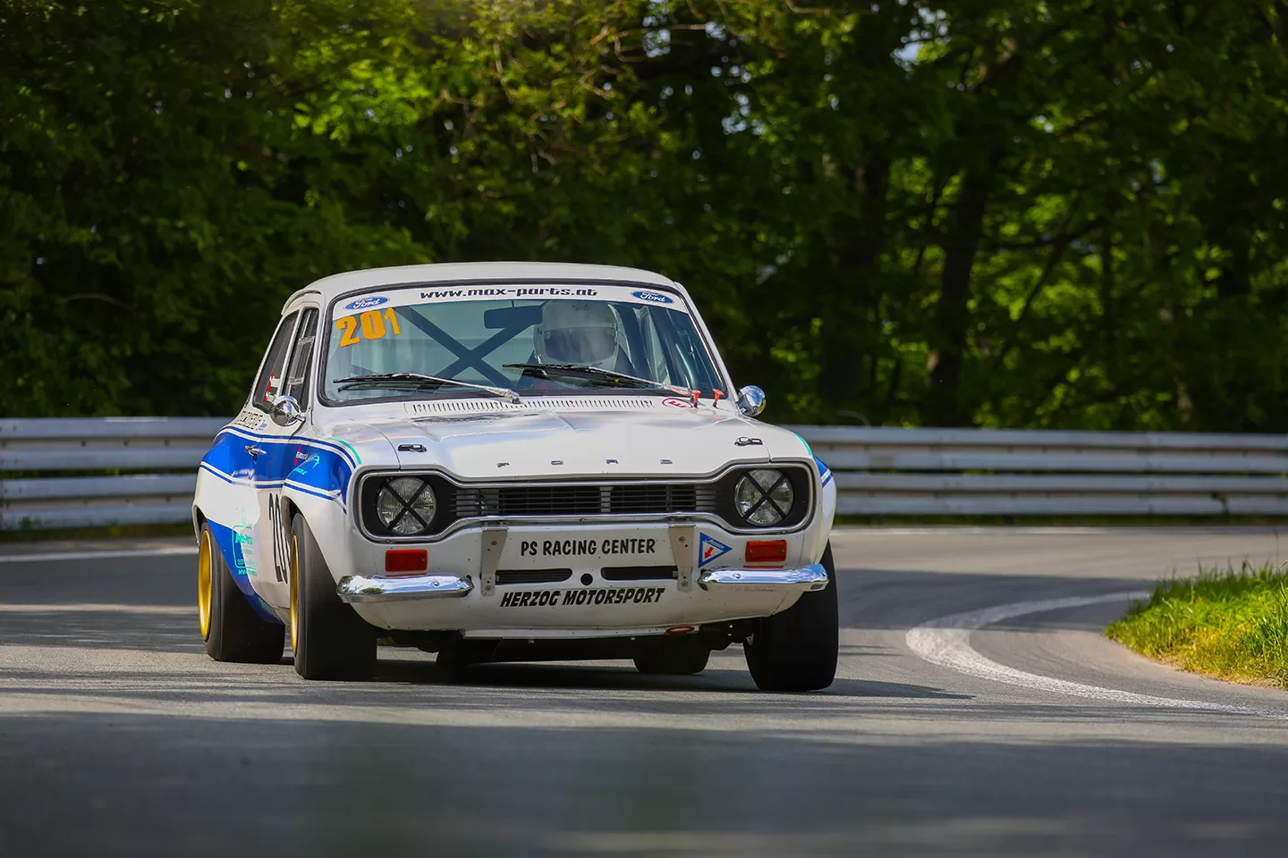 White and blue car on a track