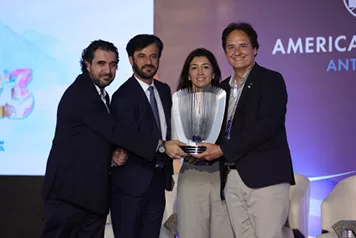 Four people, including the FIA President, holding a trophy