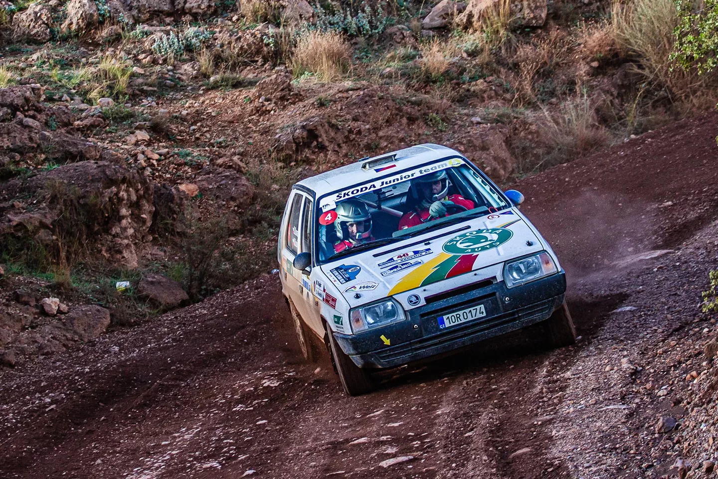 White car skidding on a dirt track