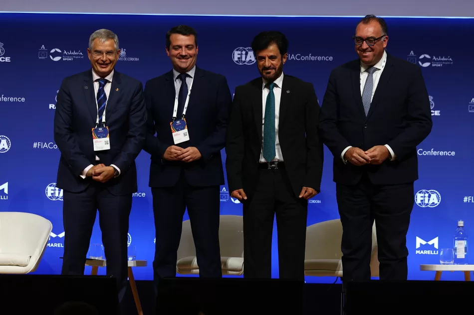 Four men wearing suits stood together