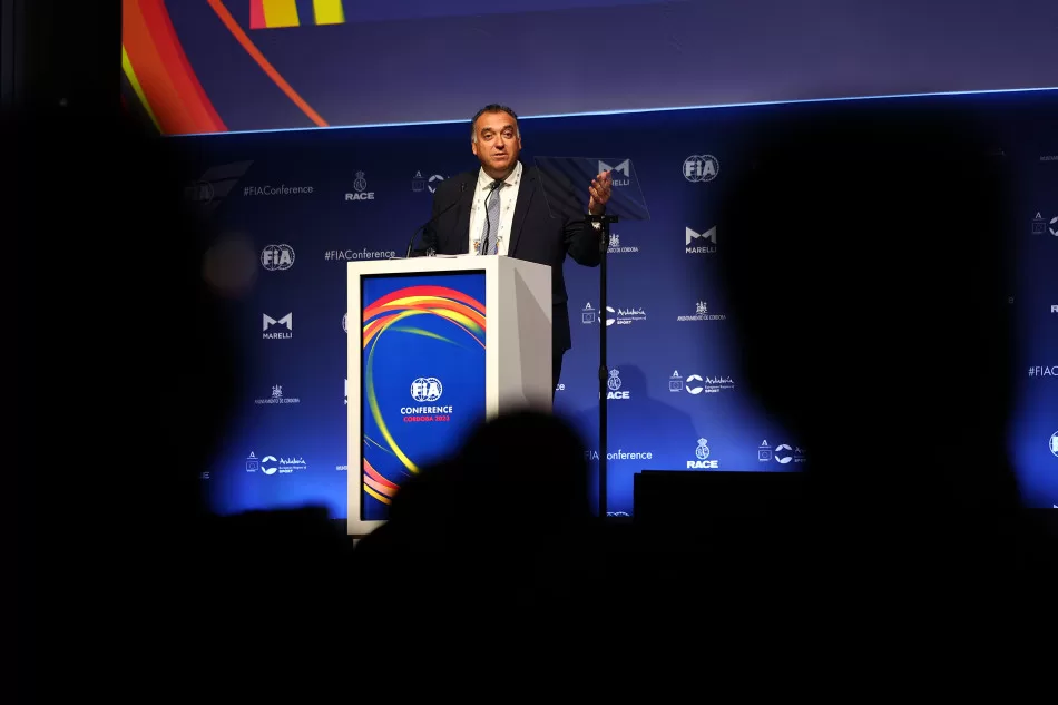 Man gives a speech from behind a podium