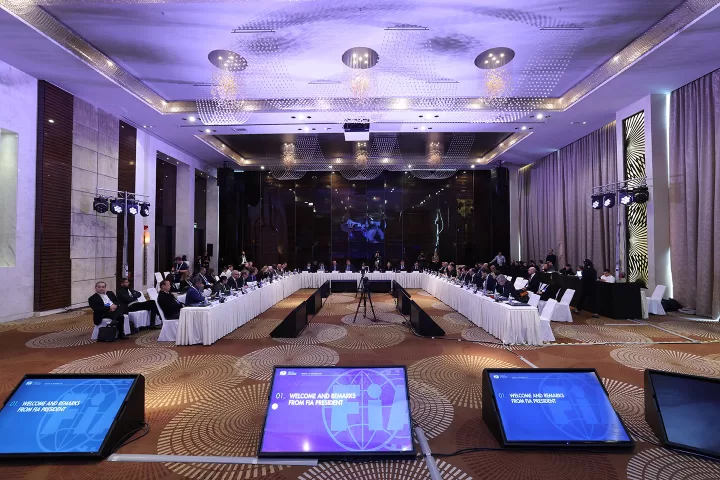 Room prepared for an event, with purple lights and monitors