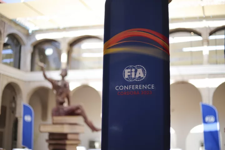 FIA Conference banner in blue with a white room backdrop