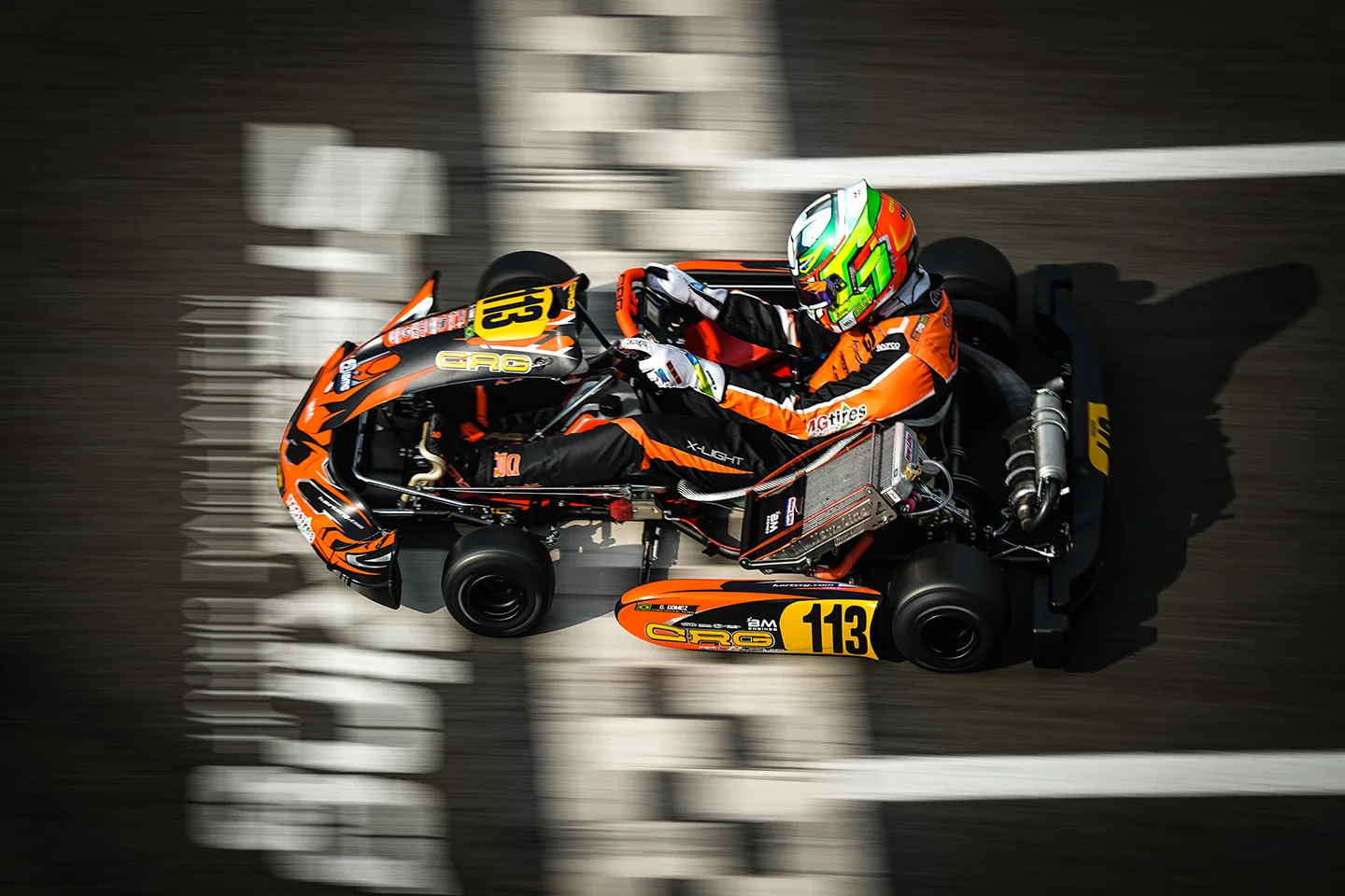 Karting driver from above, crossing the finish line