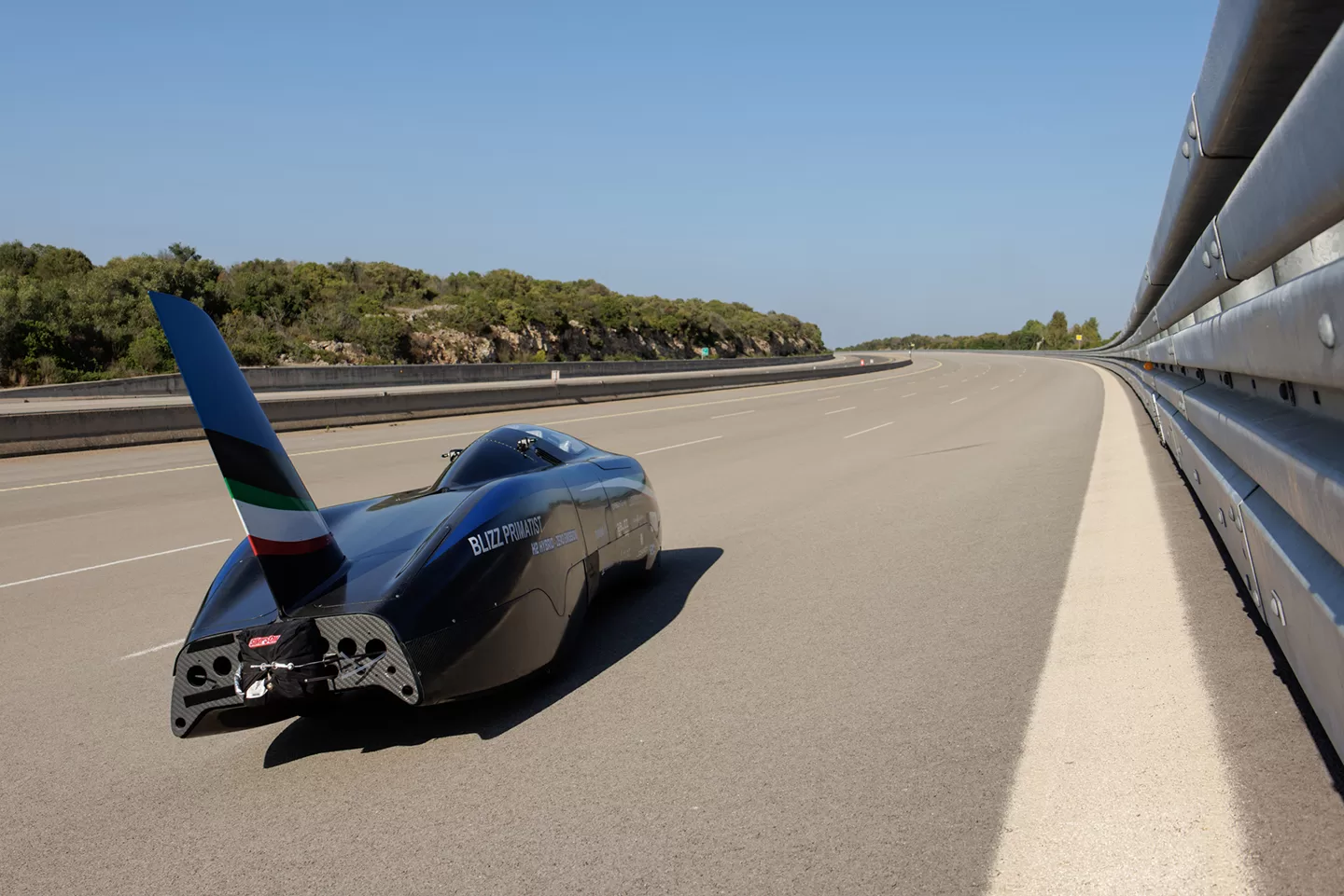 Black land racer car with large rear fin