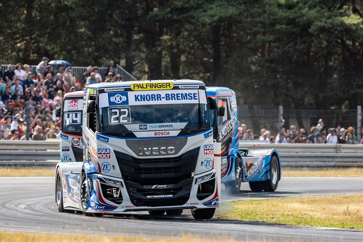 Racing trucks going around a bend