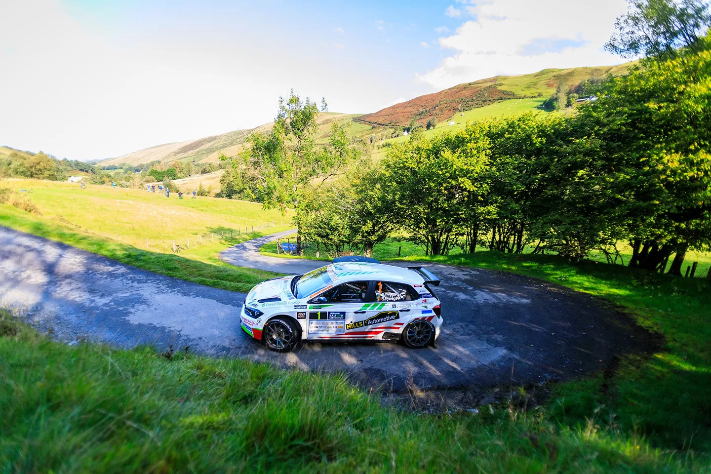 Car on countryside road in sunshine