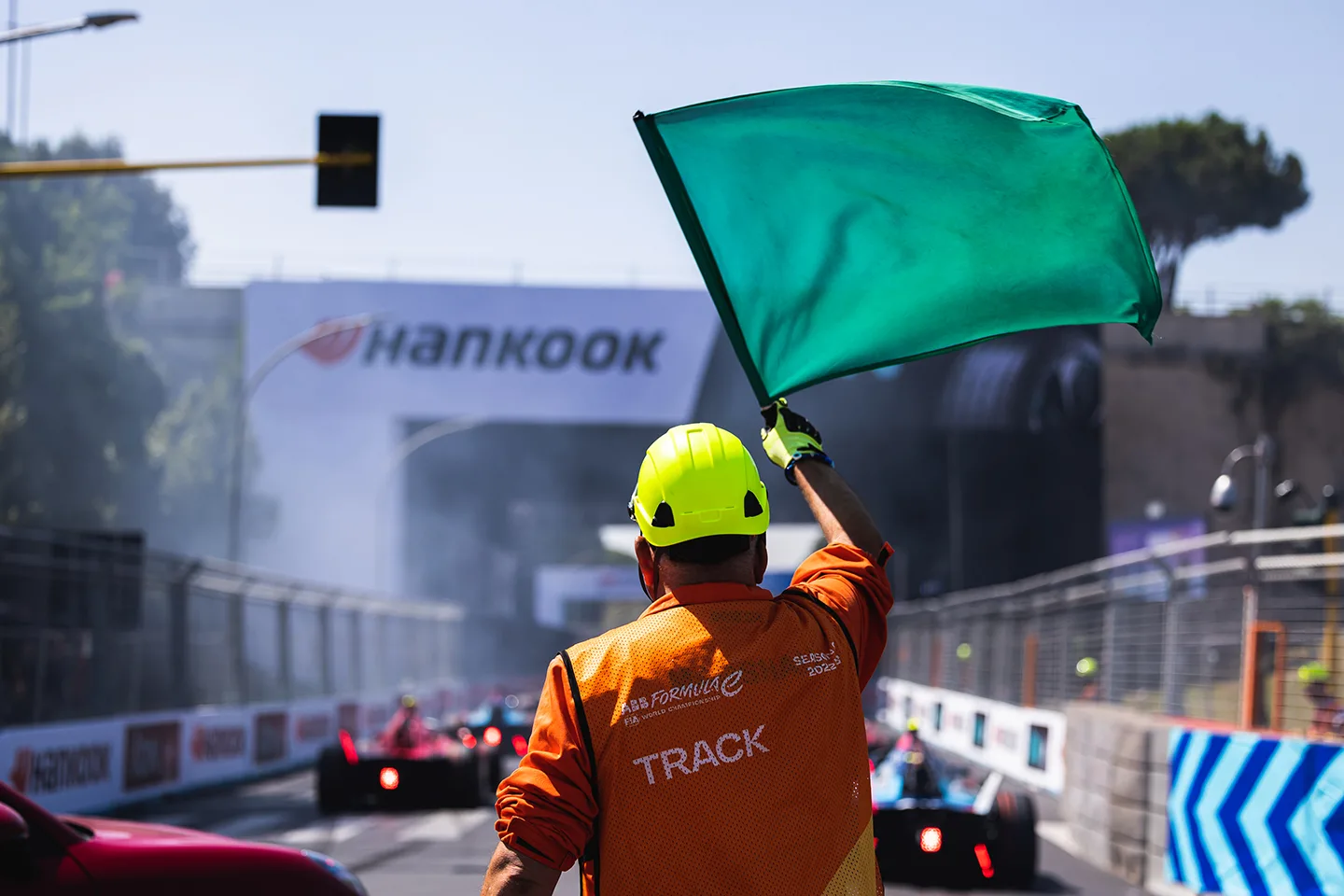 Green flag being waved at the start of a race