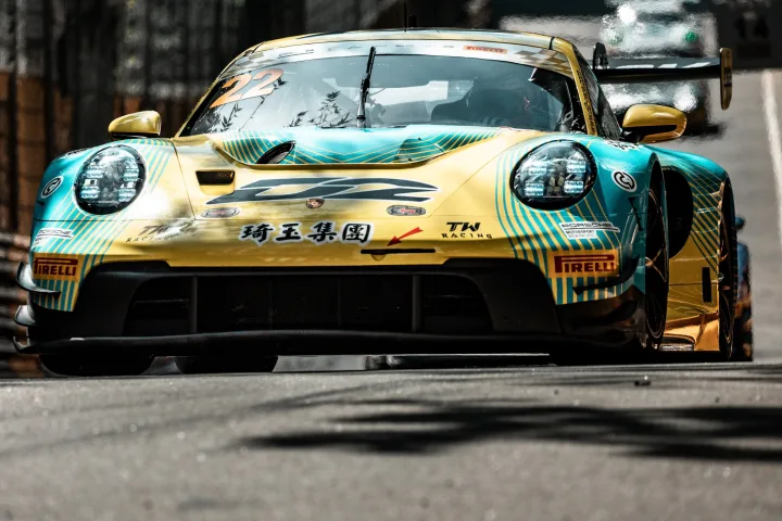 Fast low slung yellow and blue car on road