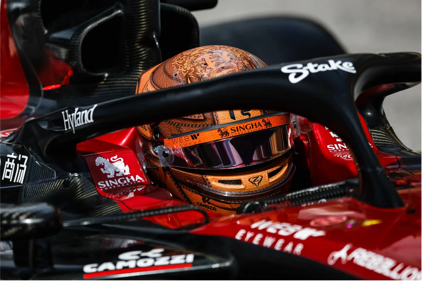 Driver wearing helmet in F1 car