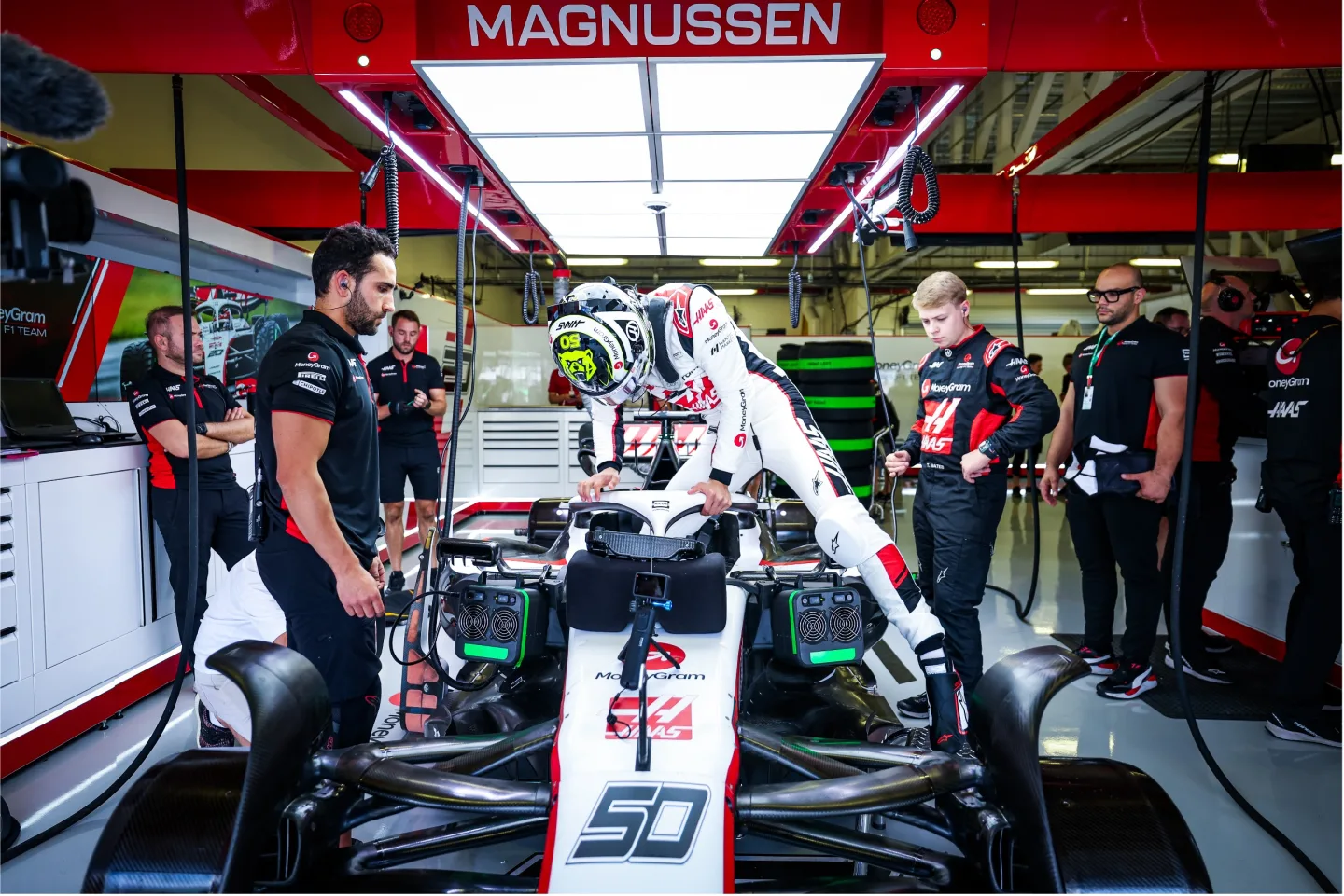 F1 driver climbs into car